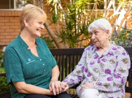 Opal Resident and Team member holding hands