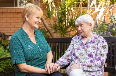 Opal Resident and Team member holding hands